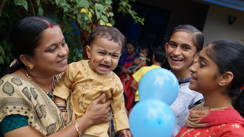 Happy Indian family celebrating investment recovery
